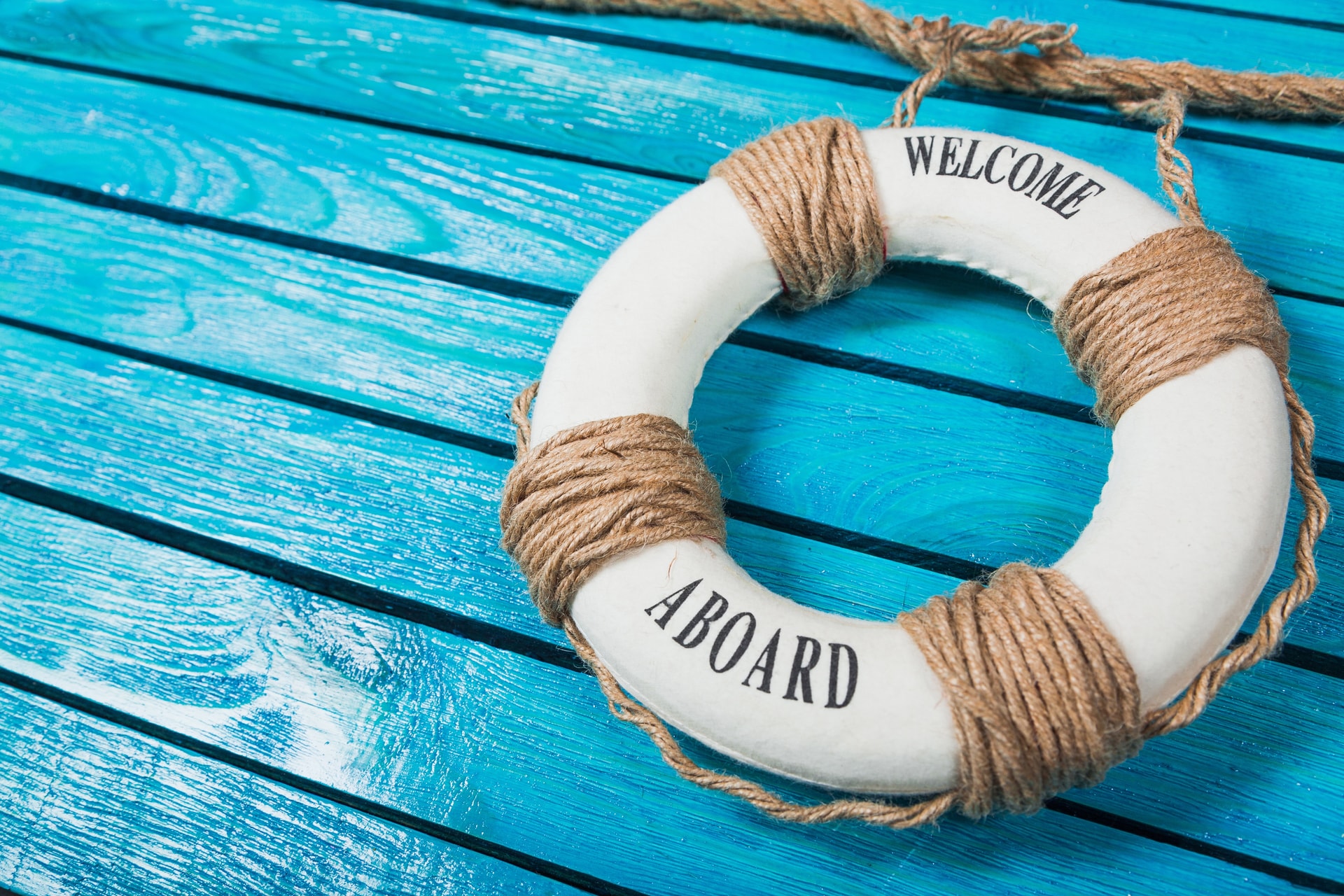 Contact Dreams e Adventures boat tours Lifebuoy on a blue wooden background — travel and boat tour concept